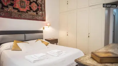 a bedroom with a white bed with towels on it at Foscari Holiday House in Rome