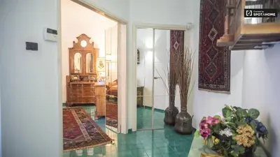 a living room with a hallway with a mirror and a room at Foscari Holiday House in Rome