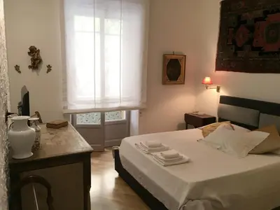 a small bedroom with a bed and a window at Foscari Holiday House in Rome
