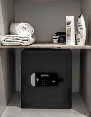 a cabinet with a phone on a shelf at NiK in Rome