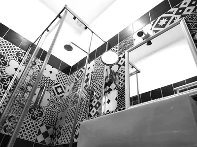 a bathroom with black and white tiles and a staircase at NiK in Rome