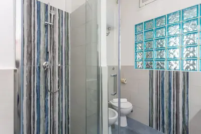 a bathroom with a toilet and a shower at Modern 2BDR apartment vibrant Prati neighborhood in Rome