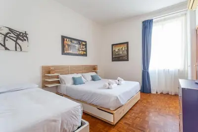 a bedroom with two beds and a window at Modern 2BDR apartment vibrant Prati neighborhood in Rome