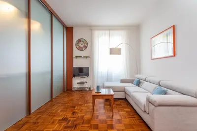 a living room with a couch and a table at Modern 2BDR apartment vibrant Prati neighborhood in Rome