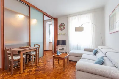 a living room with a couch and a table at Modern 2BDR apartment vibrant Prati neighborhood in Rome