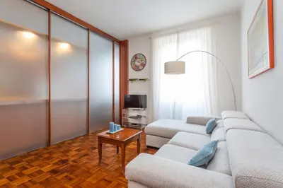 a living room with two couches and a tv at Modern 2BDR apartment vibrant Prati neighborhood in Rome