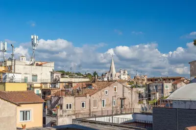 a view of a city with buildings and a cathedral at the B rooftop apartment in Rome