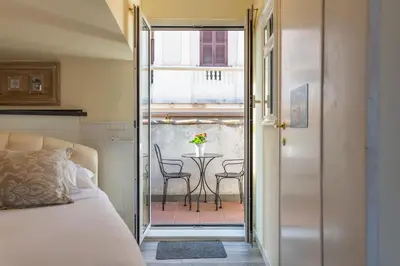 a bedroom with a bed and a table with chairs at the B rooftop apartment in Rome