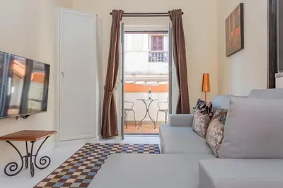 a living room with a couch and a window at the B rooftop apartment in Rome