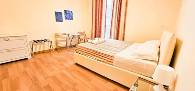 a bedroom with a bed and a table in it at Colosseum - Big and comfortable apartment in Rome
