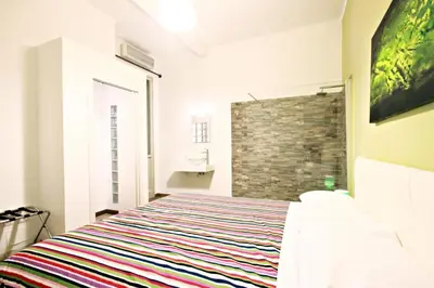 a bedroom with a bed and a brick wall at Colosseum - Big and comfortable apartment in Rome