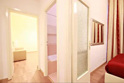 a room with a door leading to a bathroom at Colosseum - Big and comfortable apartment in Rome