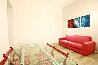 a living room with a red couch and a glass floor at Colosseum - Big and comfortable apartment in Rome