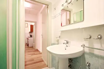 a bathroom with a sink and a mirror at Colosseum - Big and comfortable apartment in Rome