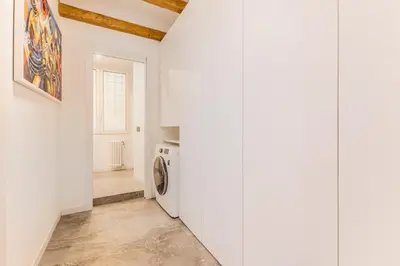 a hallway with white walls and a washing machine at Casa Borghese - Your perfect stay in Rome in Rome