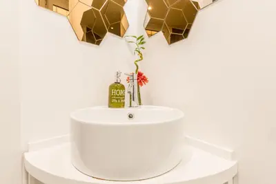 a bathroom sink with a bottle of wine on it at Casa Borghese - Your perfect stay in Rome in Rome