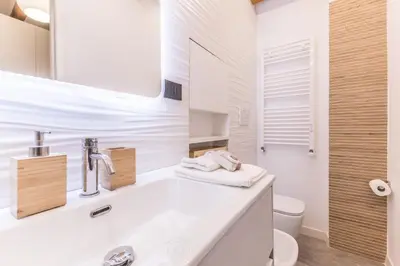 a white bathroom with a sink and a toilet at Casa Borghese - Your perfect stay in Rome in Rome