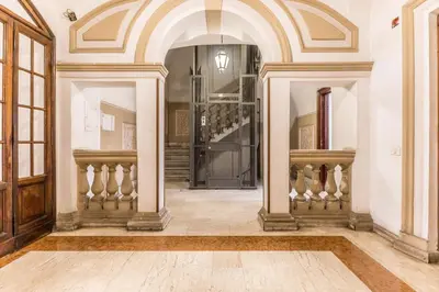 a hallway with an archway and a staircase in a house at Casa Borghese - Your perfect stay in Rome in Rome