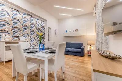 a kitchen and living room with a table and chairs at Casa Borghese - Your perfect stay in Rome in Rome
