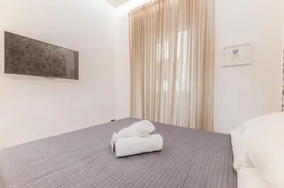 a room with a bed with a teddy bear on it at Casa Borghese - Your perfect stay in Rome in Rome