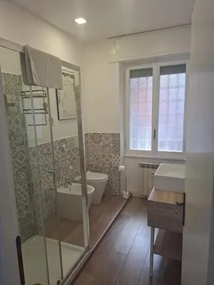 a bathroom with a shower and a toilet and a sink at La Casa di G. in Rome