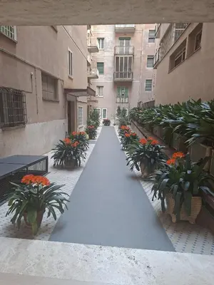 a walkway in front of a building with plants at La Casa di G. in Rome