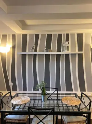 a dining room with a glass table and chairs at Residenza Morlupo (Fleming) in Rome