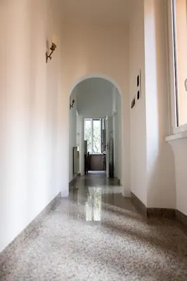 an empty hallway with an archway in a building at Alexander Vatican House in Rome