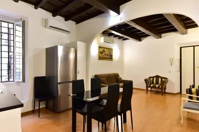 a kitchen and dining room with a table and chairs at Elite Rome apartments 3 in Rome