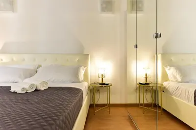 a hotel room with two beds with towels on the bed at Elite Rome apartments 3 in Rome