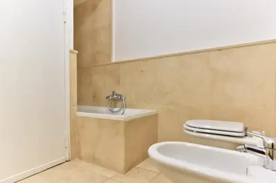 a bathroom with a white toilet and a sink at Elite Rome apartments 3 in Rome