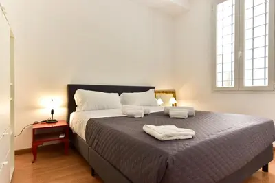a bedroom with a large bed with two towels on it at Elite Rome apartments 3 in Rome