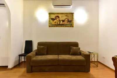 a couch in a living room with a picture on the wall at Elite Rome apartments 3 in Rome