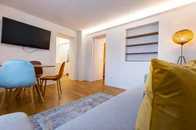 a living room with a couch and a table and a television at Vatican Vita Apartment in Rome