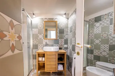 a bathroom with a sink and a mirror at Vatican Vita Apartment in Rome