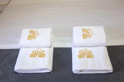 two white towels sitting on a bed at Casa Arya in Rome
