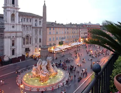 a city street with a fountain in front of a building at Casa Arya in Rome