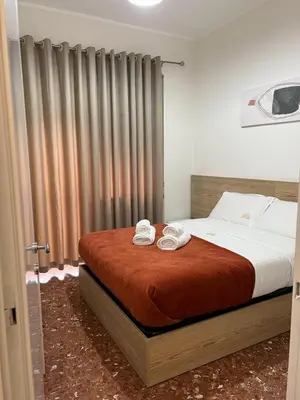 a bedroom with a bed with two towels on it at Casa Arya in Rome