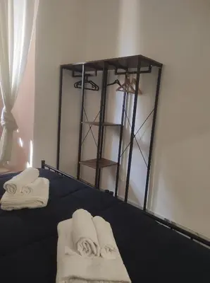 a bedroom with towels on a bed with a mirror at TIBERIVS Home in Rome