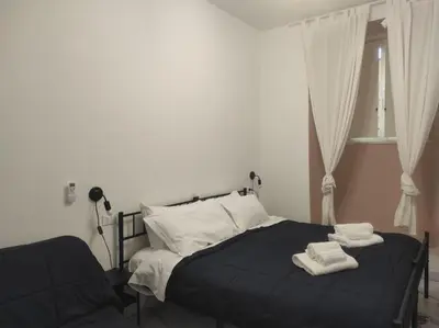 a bedroom with a bed with two towels on it at TIBERIVS Home in Rome