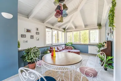 a living room with a table and chairs at Elizabeth Penthouse, Charmy Apartment in Little London 10 Min From the Center in Rome