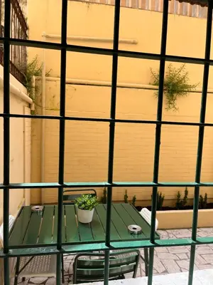 a green table with a potted plant on a patio at Loft Villa Blanc in Rome
