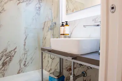 a bathroom with a sink and a shower at Hotel AD Suites Nazionale in Rome