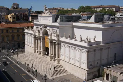 a large white building with a staircase in a city at Glam Luxury Rome in Rome