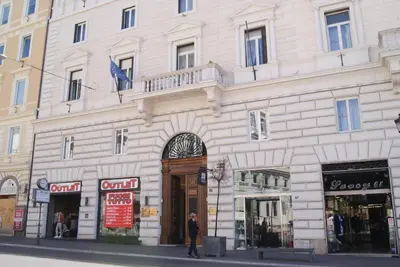 a man is standing in front of a building at Glam Luxury Rome in Rome