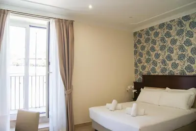 a hotel room with a bed and a window at Glam Luxury Rome in Rome