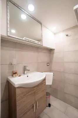 a bathroom with a sink and a mirror at Popolo Pen 3 Apartament in Rome