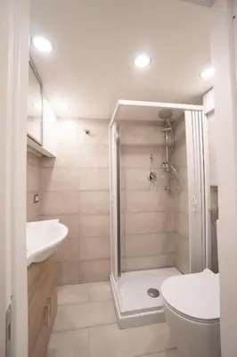 a bathroom with a shower and a toilet and a sink at Popolo Pen 3 Apartament in Rome