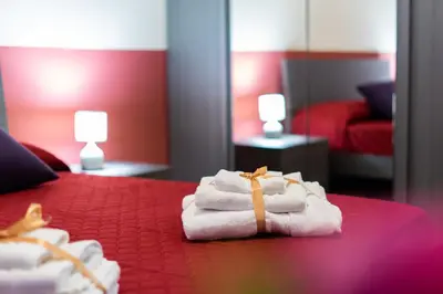 a pile of towels sitting on a bed in a room at HolidayHomeNazzarena in Rome