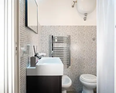 a small bathroom with a sink and a toilet at HolidayHomeNazzarena in Rome